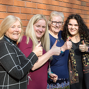 Four women signing Good