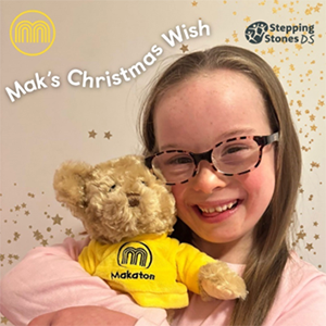 Young girl with Down's syndrome cuddling Mak the Bear